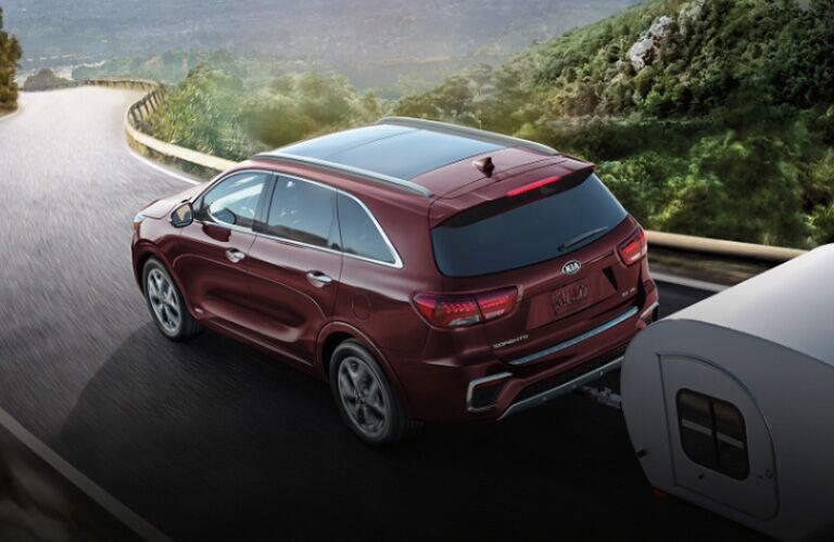 Red 2020 Kia Sorento towing a trailer