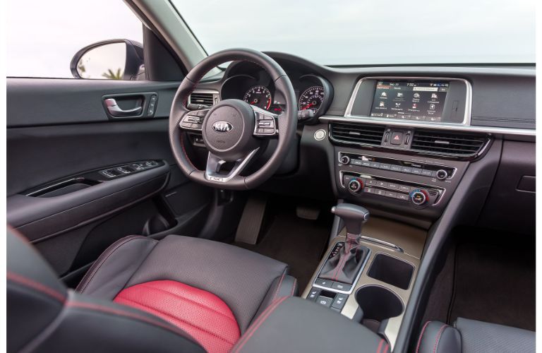 Dark grey dashboard and dark grey and red front seats in 2020 Kia Optima