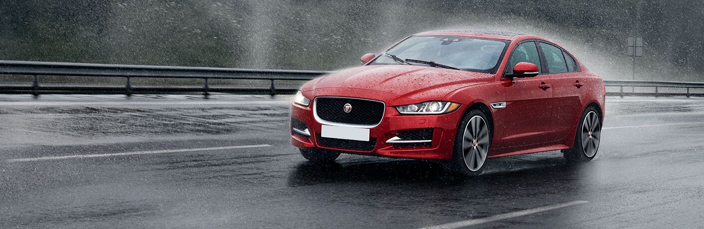 front view of the 2017 Jaguar XE 20d driving in the rain