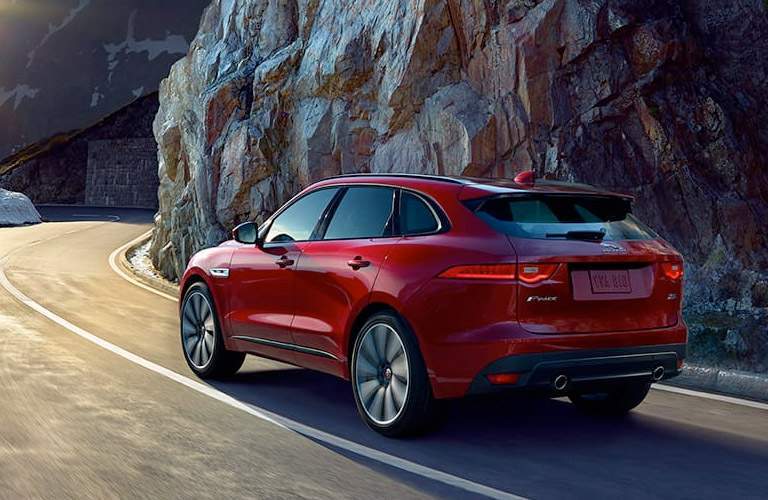 rear view of a red 2018 Jaguar F-PACE on a mountain