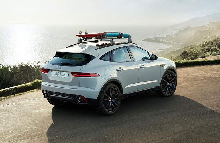 white 2018 Jaguar E-PACE driving with a water background