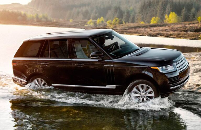 black 2016 Land Rover Range Rover fording a river
