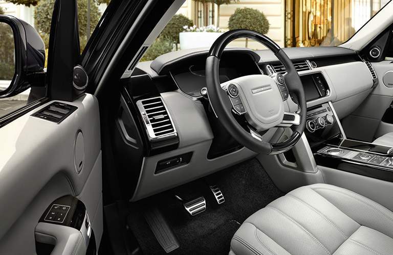 driver cockpit of the 2017 Land Rover Range Rover seen from the open side door
