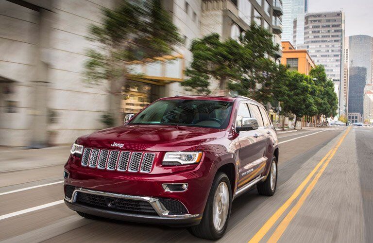 red 2016 Jeep Grand Cherokee in the city