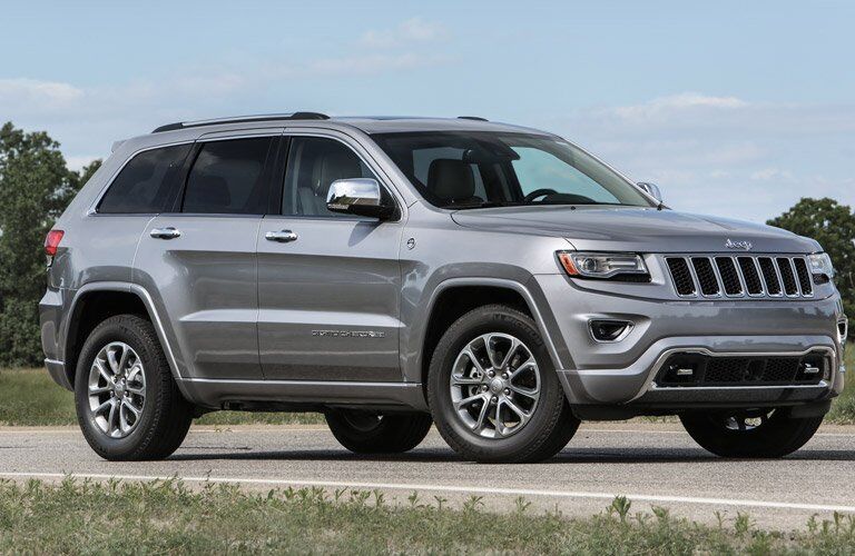 grey 2016 Jeep Grand Cherokee on the road