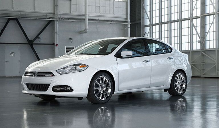 white Dodge Dart in a warehouse