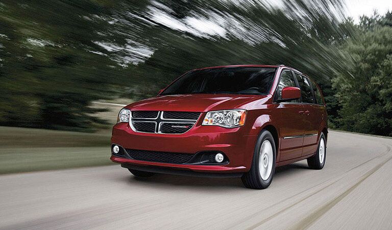 red 2016 Dodge Grand Caravan going very fast on the road