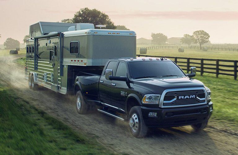 2017 Ram 3500 pulling a motor home down a country road