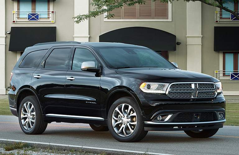side view of a black 2018 Dodge Durango parked in front of an apartment