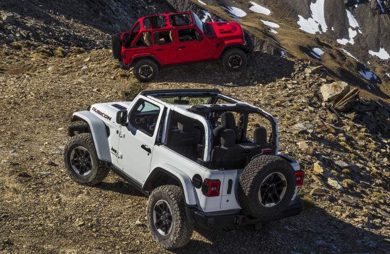 white and red all-new 2018 Jeep Wrangler parked on rocks