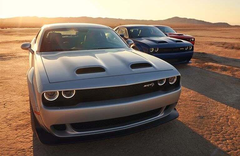 three 2019 Dodge Challenger models parked side by side