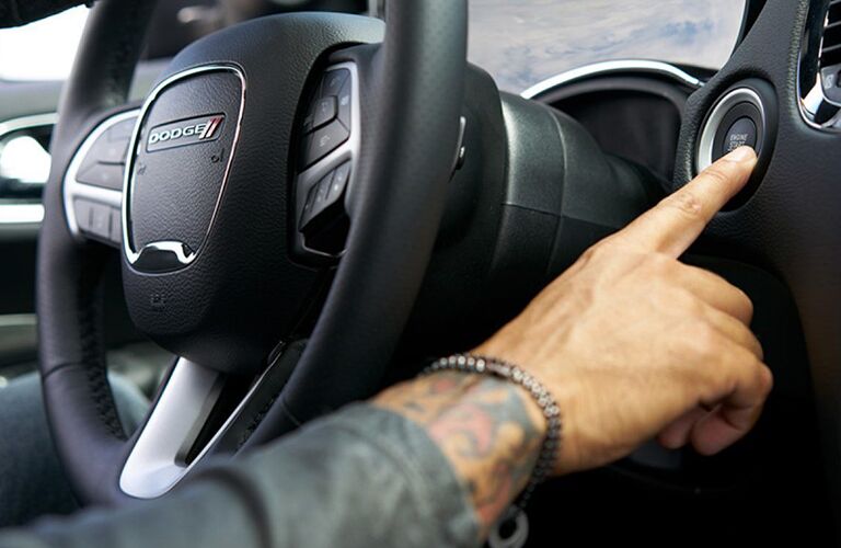 Hand pushing start button in 2019 Dodge Durango