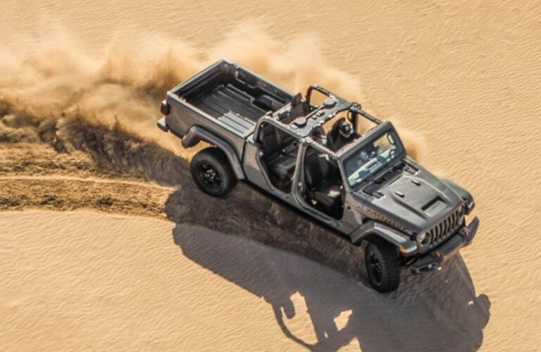 2021 Jeep Gladiator driving over sand dune