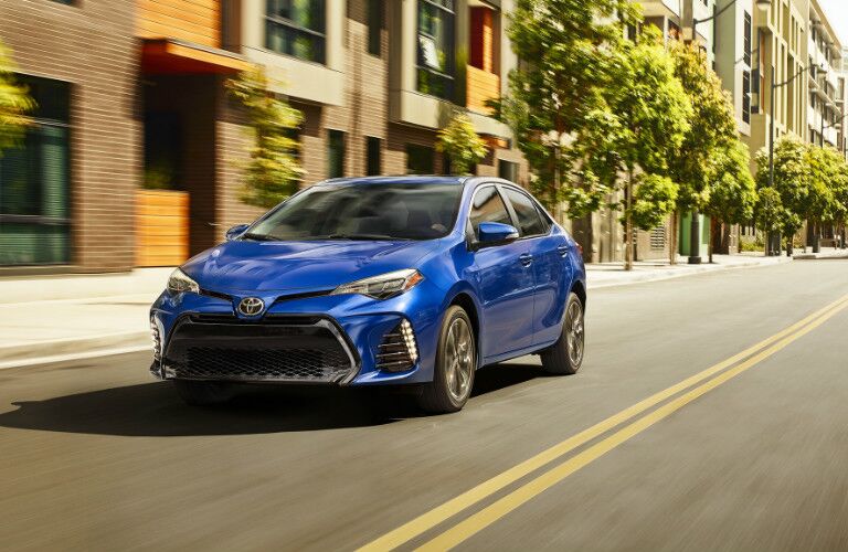 2019 Toyota Corolla in blue driving on a city street