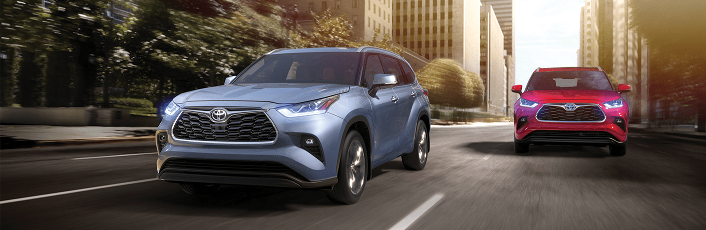 Two 2020 Toyota Highlander models driving on a city street