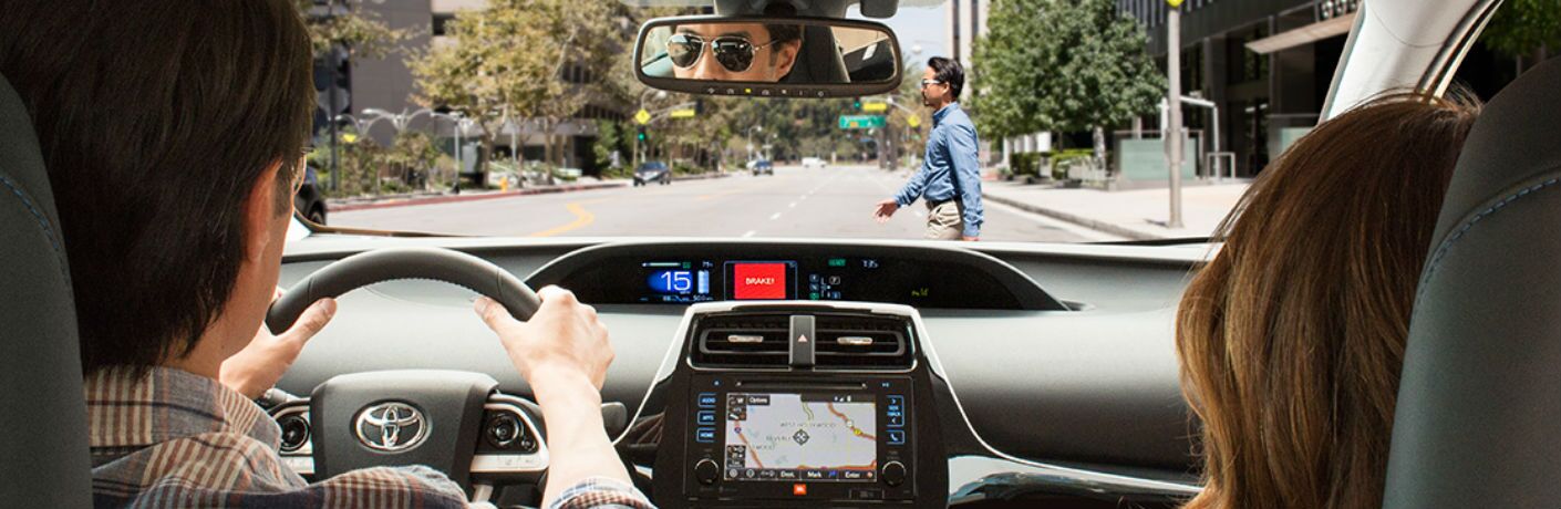Toyota driver being alerted to a pedestrian via Toyota Safety Sense on their dashboard