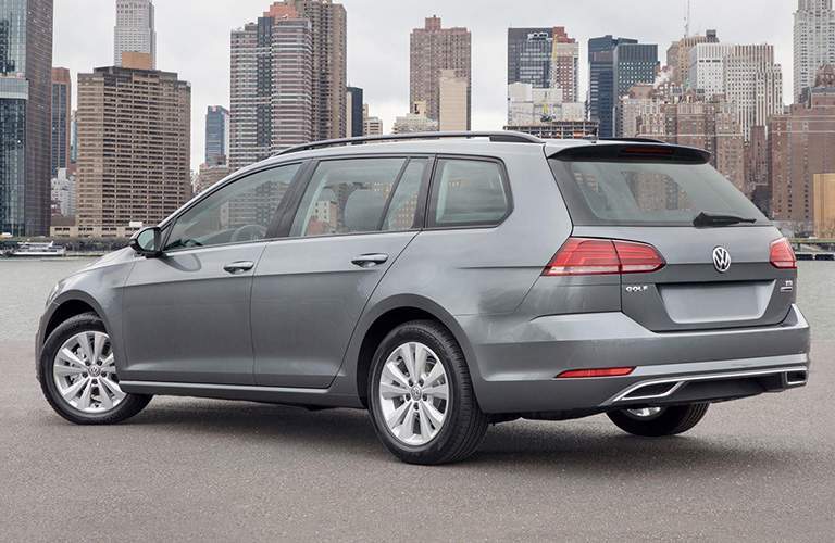 gray 2018 VW Golf SportWagen in front of city skyline exterior rear driver side view