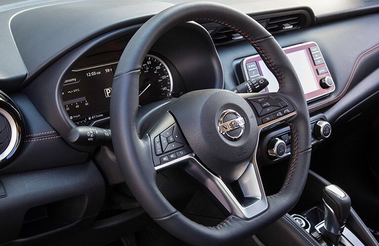 front interior of 2018 nissan kicks including steering wheel and infotainment system