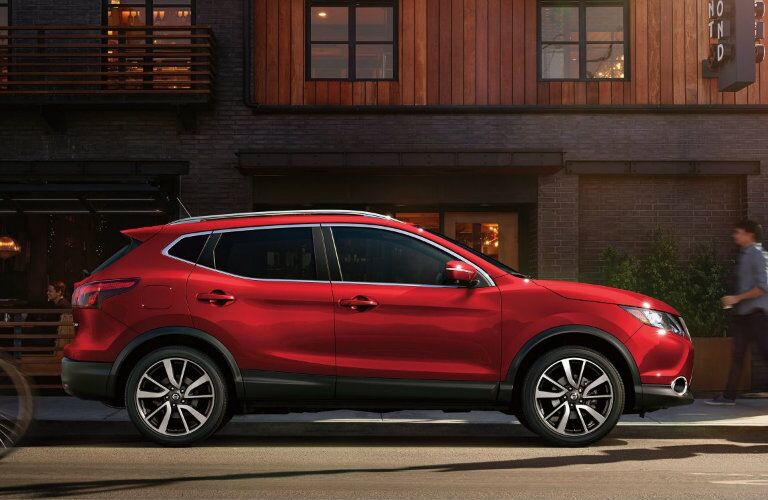 red 2018 nissan rogue sport parked on city street