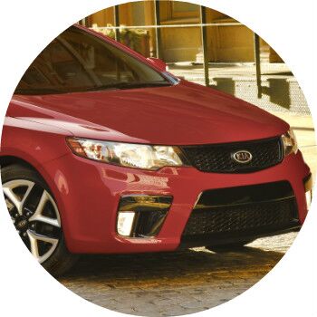 red 2013 Kia Forte front grille and headlights