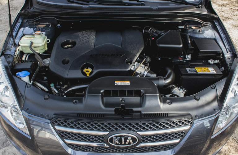 Shot of Kia vehicle with hood open exposing engine