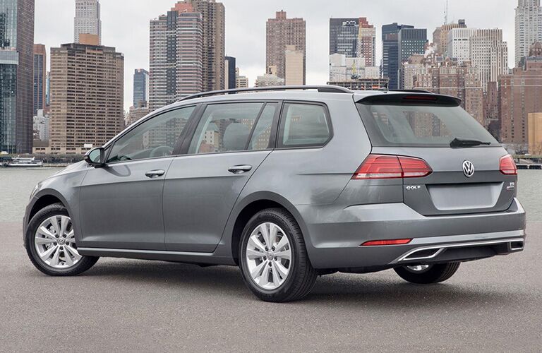 Silver Volkswagen Golf Sportwagen parked with a city backdrop.