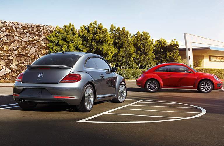 Two 2018 Volkswagen Beetle models parked together in a parking lot