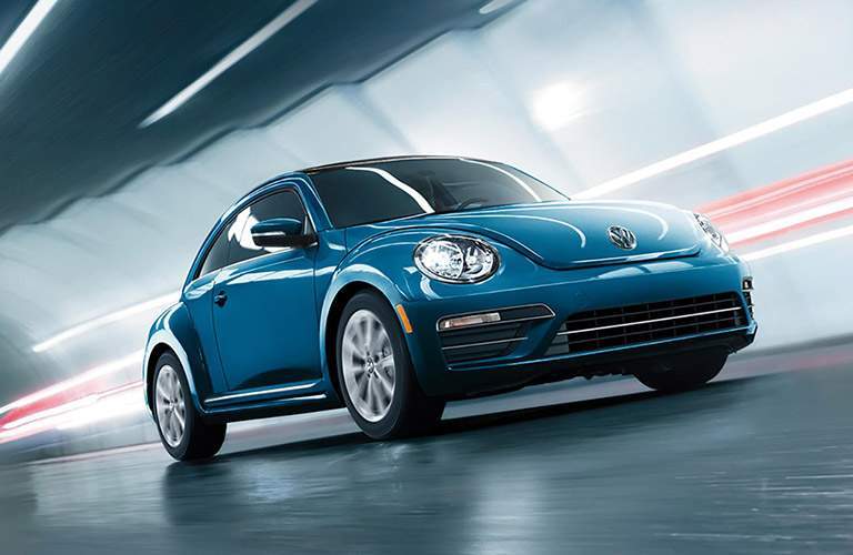 2018 Volkswagen Beetle in blue driving through a tunnel