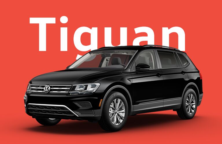 Black Volkswagen Tiguan sits in front of a red background beneath giant white text that reads, "Tiguan."
