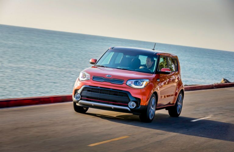 A left front quarter photo of the 2019 Kia Soul driving by the ocean.