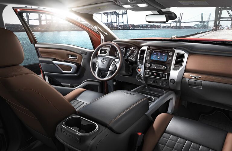 front interior of 2018 nissan titan xd including steering wheel, center console and infotainment system