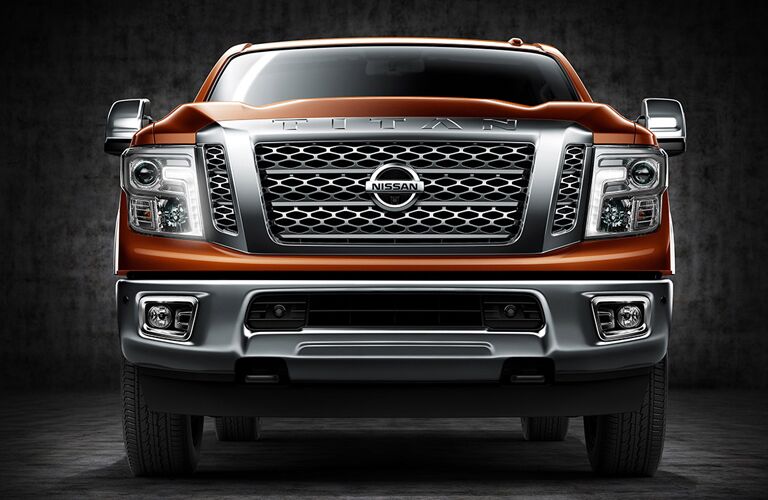 front view of bumper and grille of orange 2018 nissan titan xd