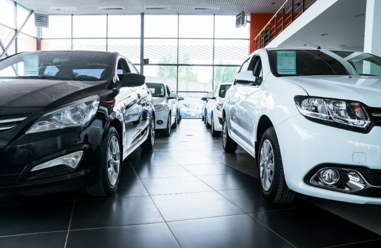 black and white new cars at car dealership