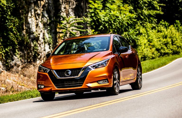 A head-on photo of the 2020 Nissan Versa in motion on the road.