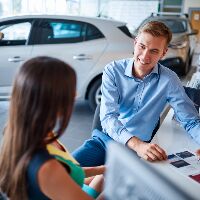 Woman and salesman talking at the dealership