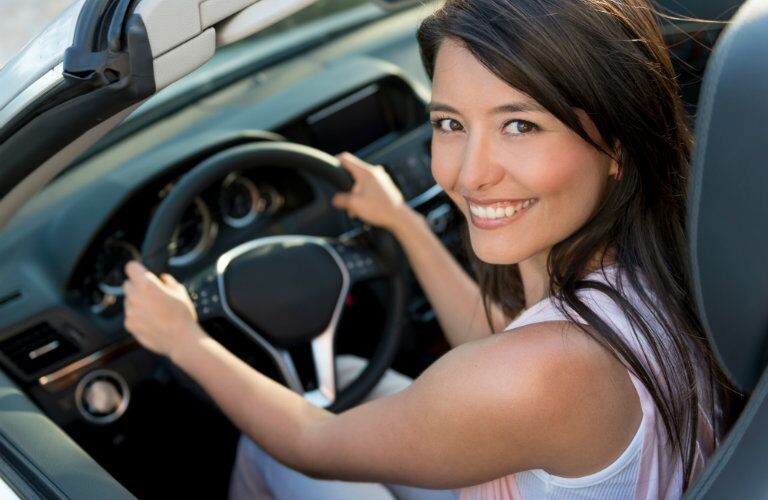 used car buyer enjoying her new vehicle