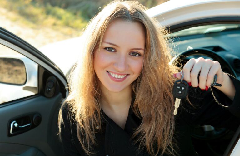 car owner showing keys to her used manual transmission car