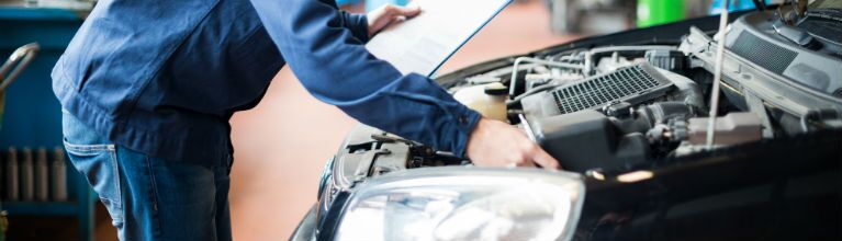 image of a mechanic checking a car's engine