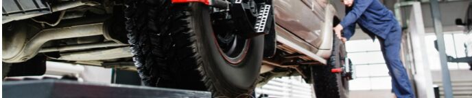 mechanic working on a vehicle's tires