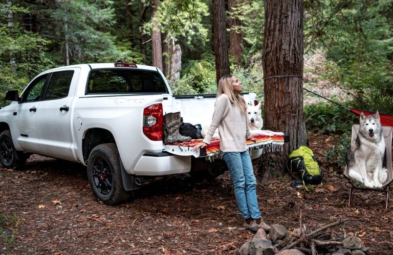 woman standing near the trunk of a Toyota truck