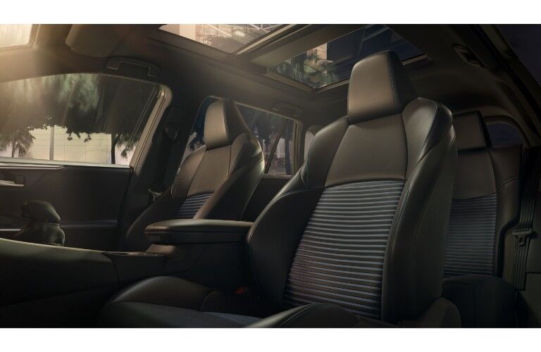 2019 Toyota RAV4 interior shot of softex faux leather seating surfaces with sun coming in from the panoramic moonroof