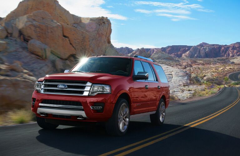 Red 2017 Ford Expedition driving along road