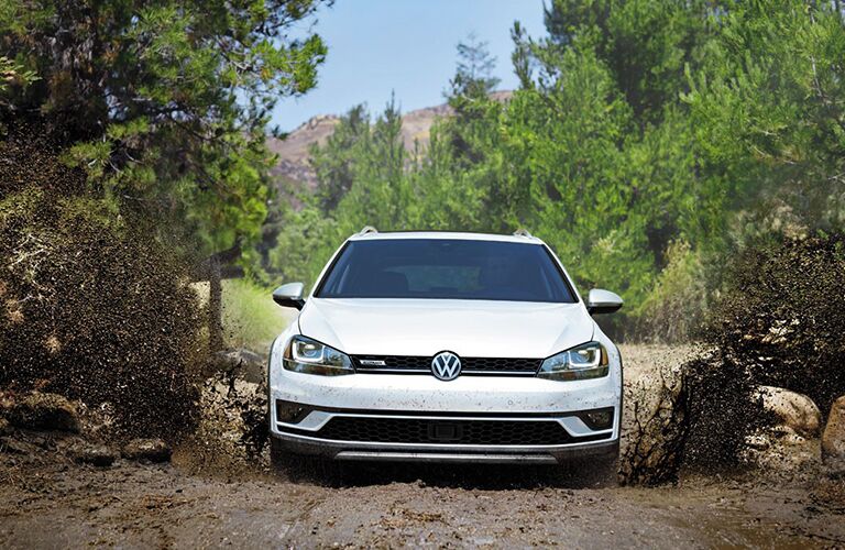 white 2018 Volkswagen Golf Alltrack driving in mud