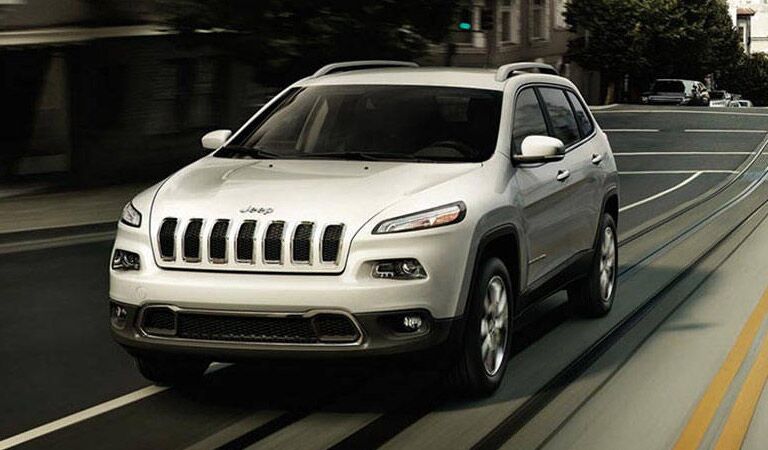 white 2016 Jeep Cherokee on the road