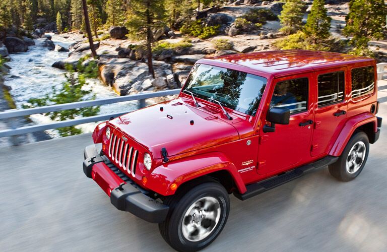 red 2016 Jeep Wrangler Unlimited on a bridge