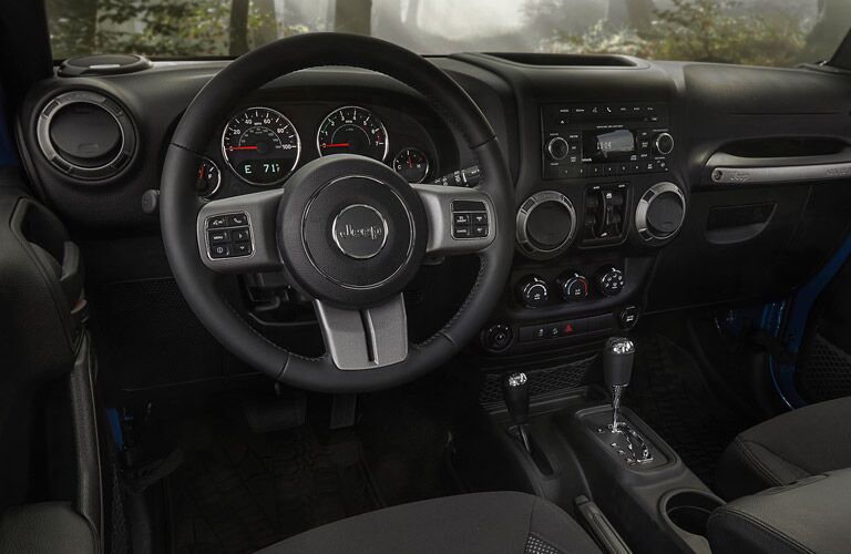 steering wheel and dashboard view of the 2016 Jeep Wrangler Unlimited