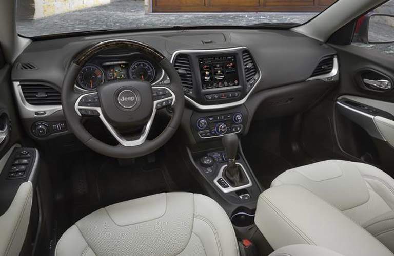 dashboard, including steering wheel and Uconnect infotainment system, of the 2018 Jeep Cherokee