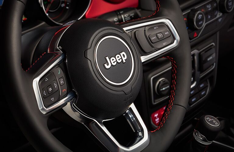 2018 Jeep Wrangler steering wheel with Jeep branding and lots of buttons