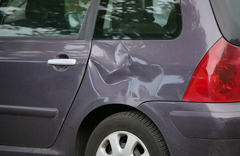deep but repairable dent over a wheel