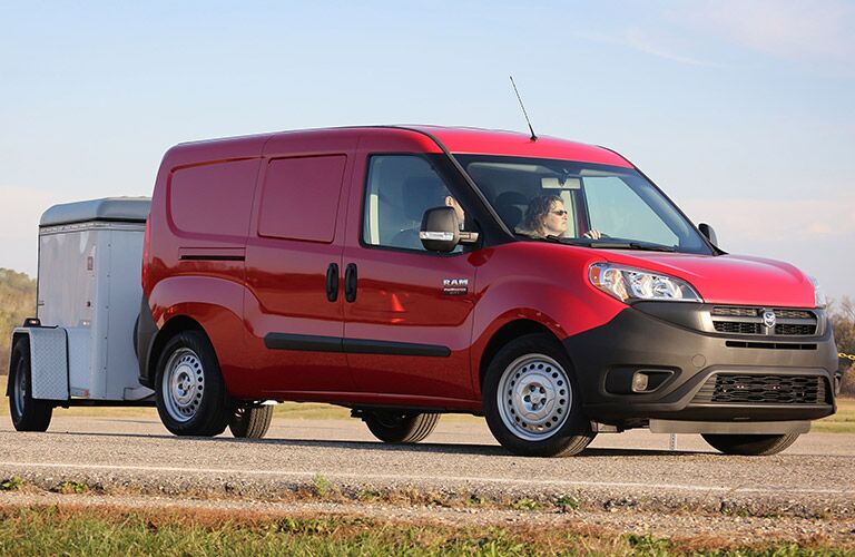 red 2017 Ram ProMaster City towing a trailer